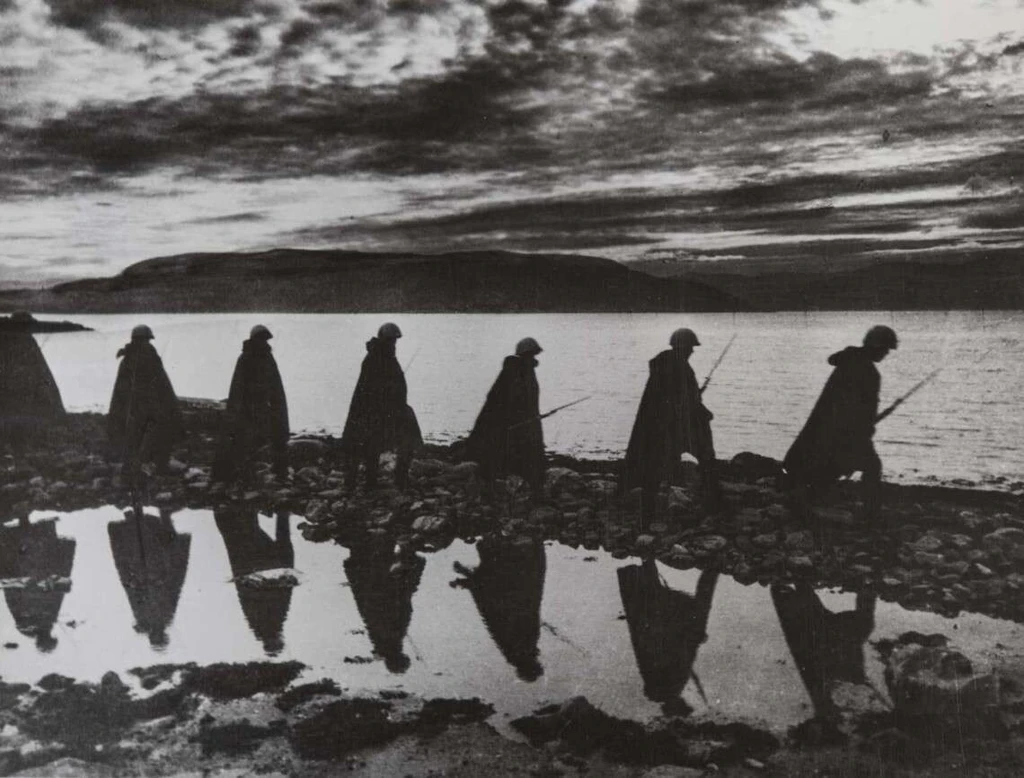  Black and white motif, graphic image of marching soldiers by the sea