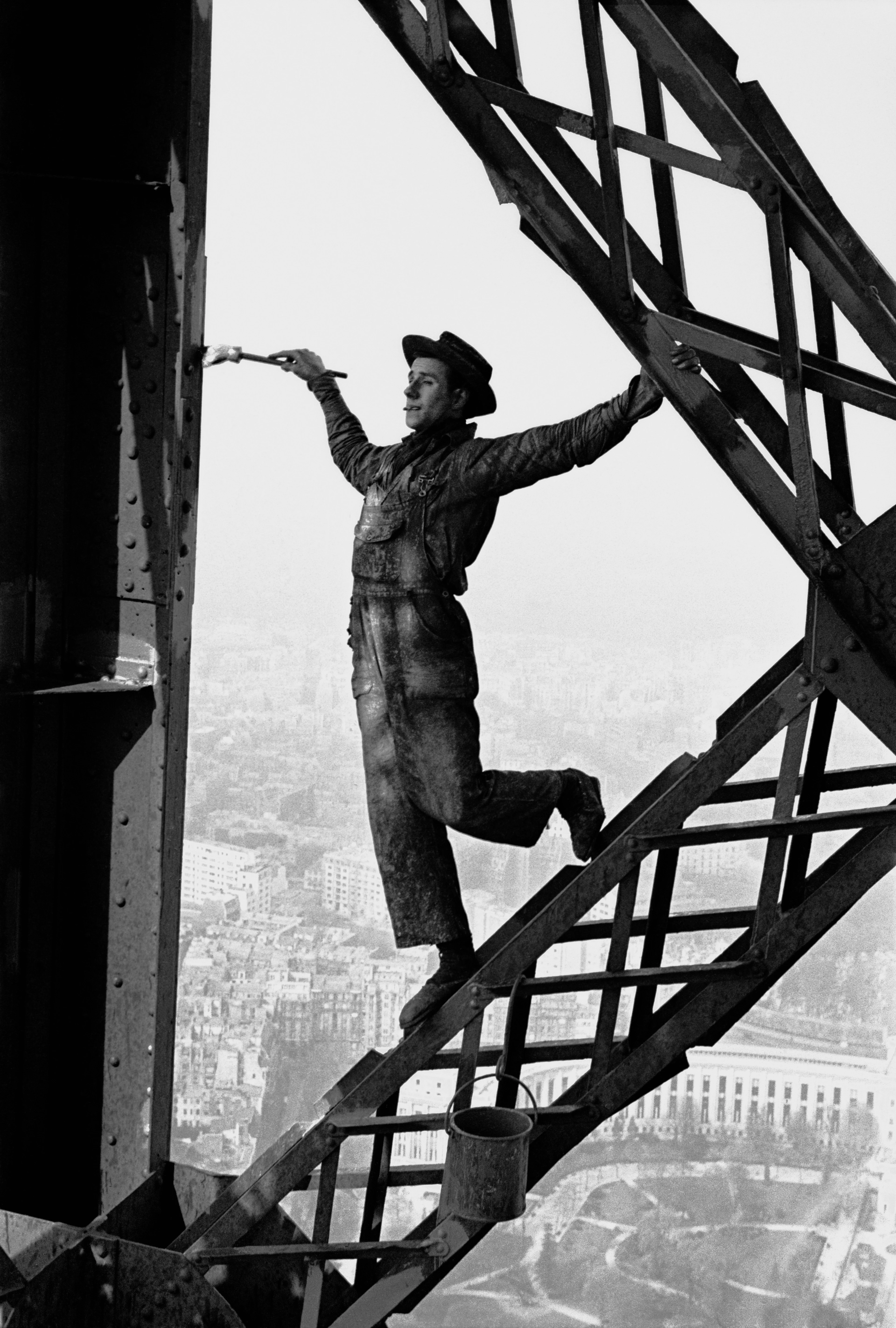 Black and white motif, man skipping across the struts of the Eiffel Tower