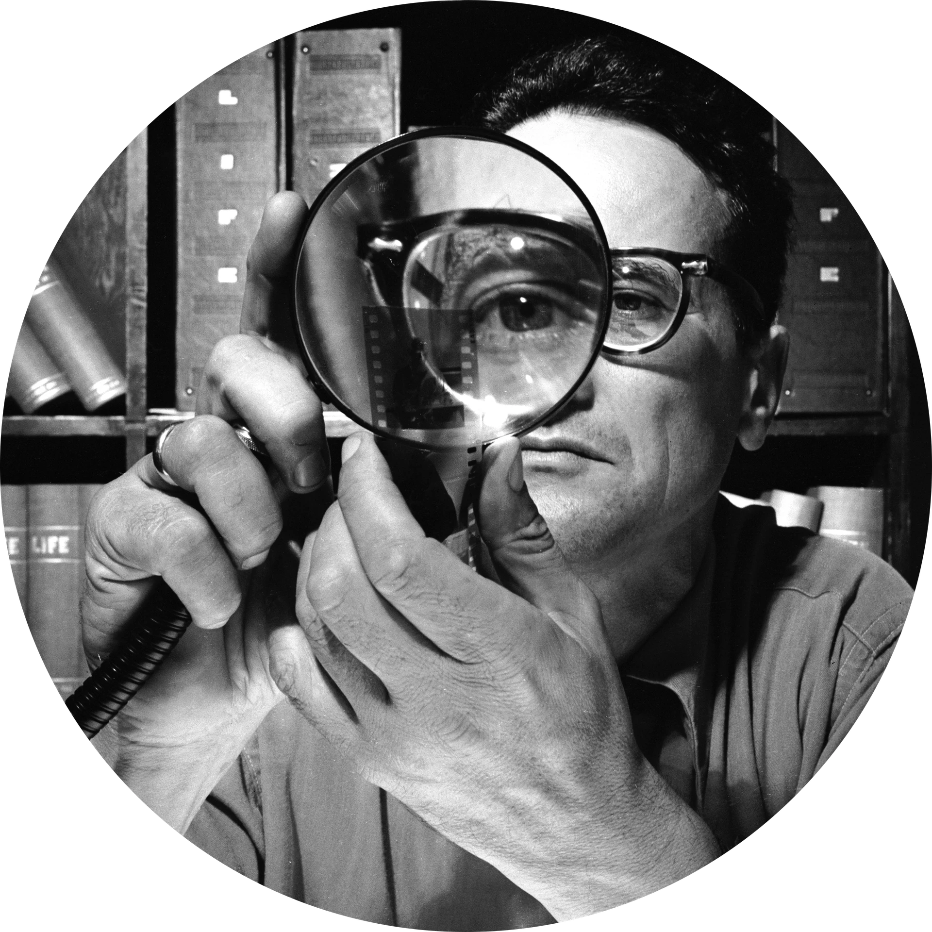 Black and white motif, Andreas Feininger looks at a negative through a magnifying glass