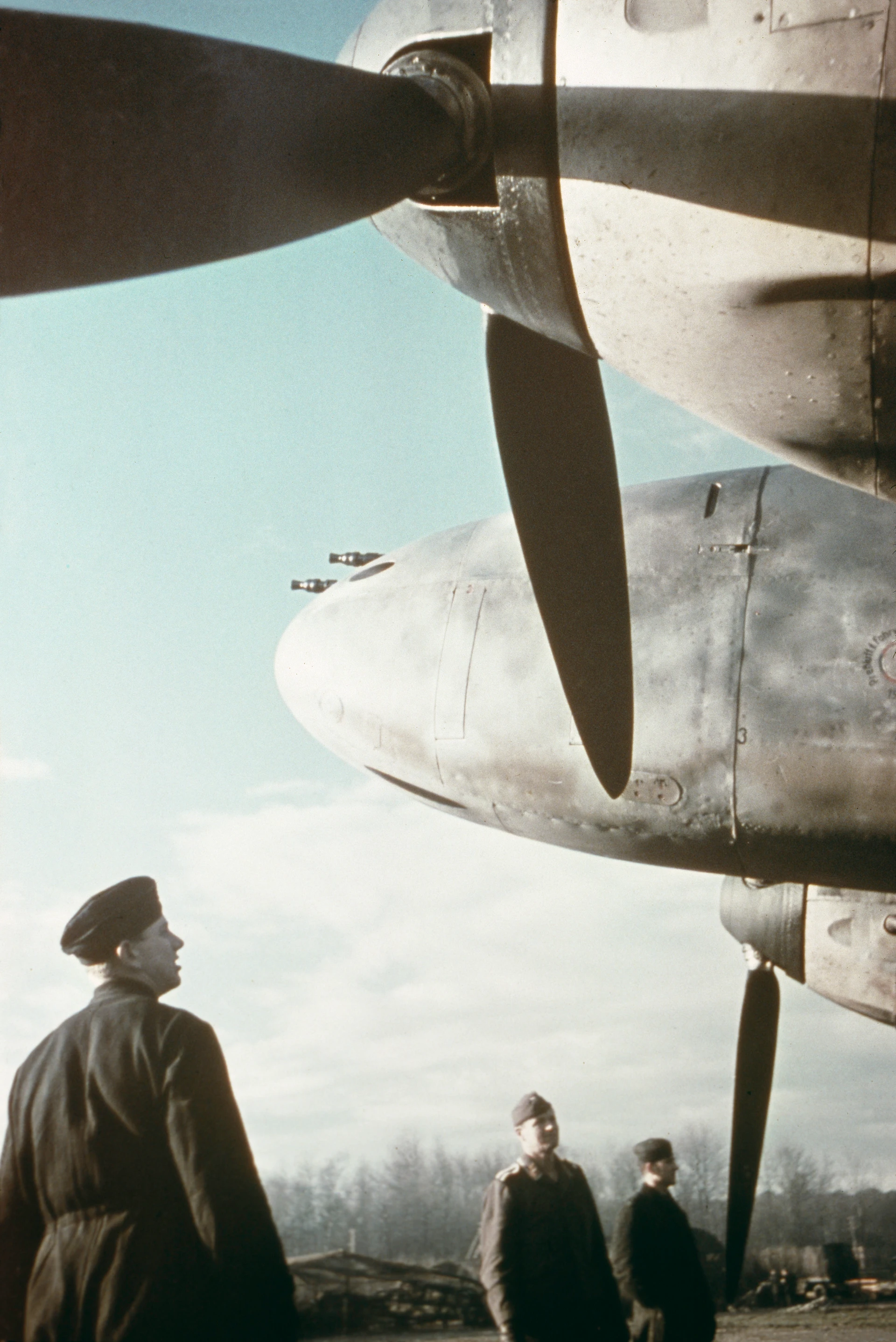 The crew of a Messerschmitt Me 110 destroyer on an airfield along the Channel coast, standing in front of their aircraft
