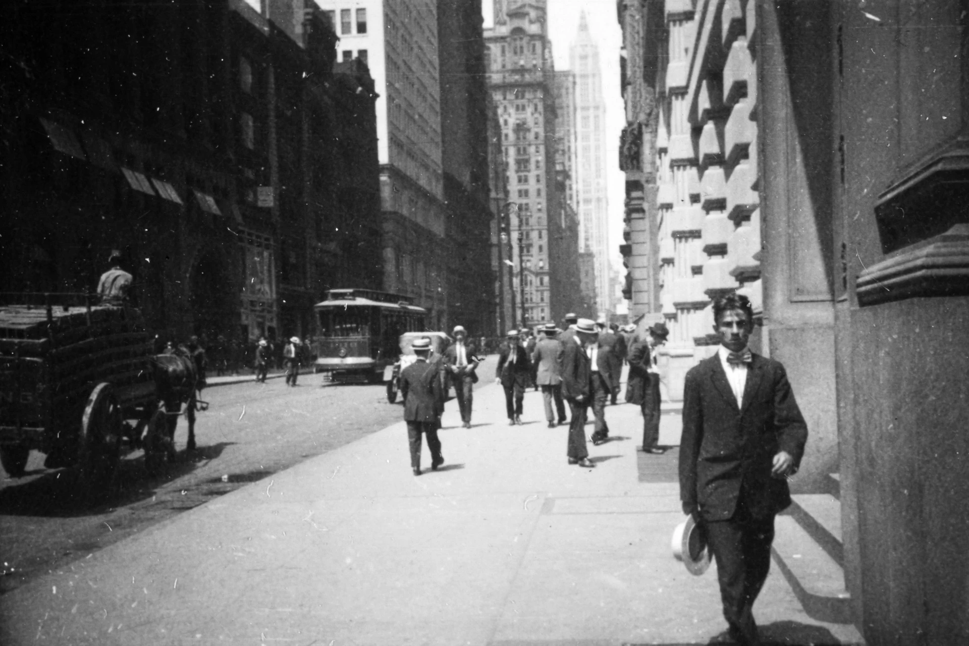 Black-and-white image, people walking down a street in New York in 1914